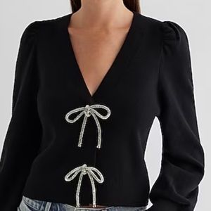 Express sweater with rhinestone bow embellishments. Stunning on. Worn once.